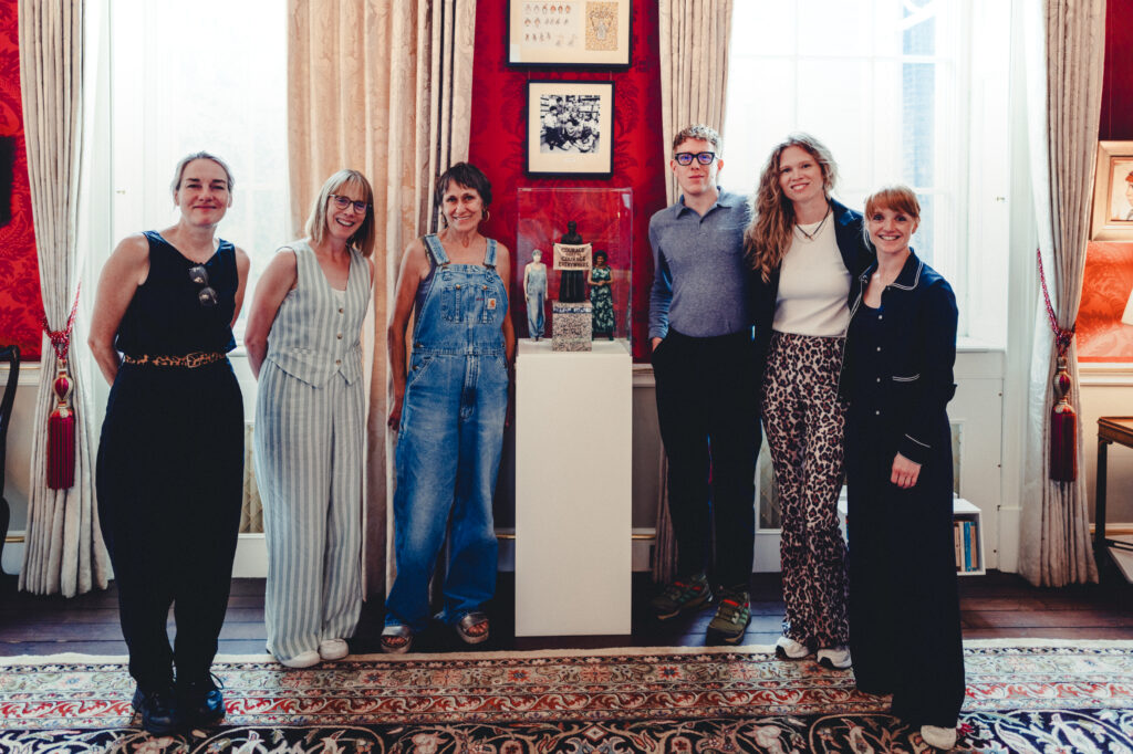 The non zero one and National Trust teams with Sheila by the statues